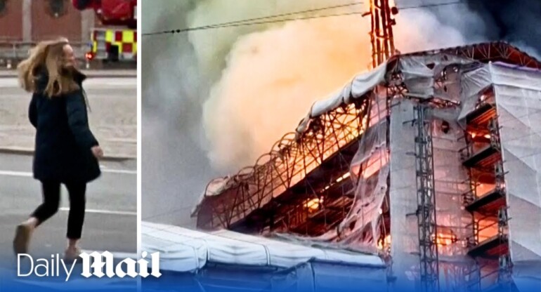 Emotional woman attempts to enter Copenhagen's burning stock exchange