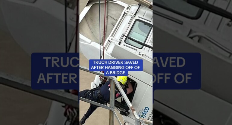 Truck driver saved after hanging off BRIDGE!