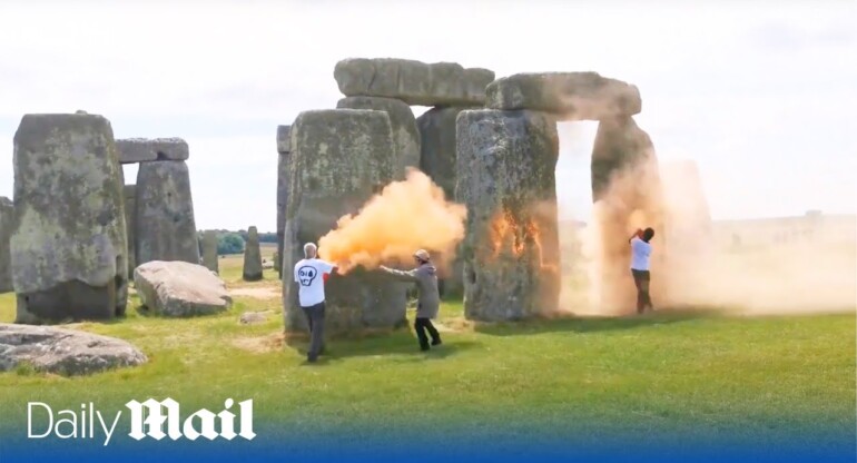 Just Stop Oil spray Stonehenge with orange paint as heroic passer-by tries to drag them away