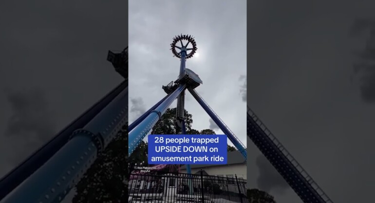 Moment thrill-seekers scream as they are left dangling upside down after ride breaks down