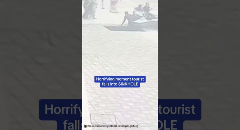 Horrifying moment tourist falls into SINKHOLE