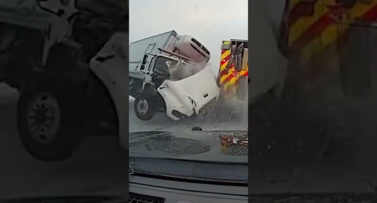 Terrifying moment truck smashes into emergency vehicles